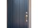 Close up of the modern style, dark colored front door with a new handle and locking system at 14355 59Th E Cir, Bradenton, FL 34211