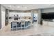 Open-concept kitchen featuring a large center island with pendant lighting and white cabinetry at 14355 59Th E Cir, Bradenton, FL 34211