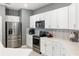 Modern kitchen featuring stainless steel appliances, white cabinets, and decorative backsplash at 14355 59Th E Cir, Bradenton, FL 34211