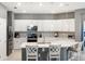 Modern kitchen featuring an island, pendant lighting, stainless appliances, and white cabinetry at 14355 59Th E Cir, Bradenton, FL 34211