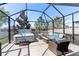Enclosed lanai with a relaxing hot tub and comfortable seating area, creating a private outdoor retreat at 14355 59Th E Cir, Bradenton, FL 34211