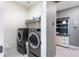 Well-equipped laundry room with front-load washer and dryer and decorative shelving at 14355 59Th E Cir, Bradenton, FL 34211
