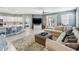 Spacious living area with a large sectional, tile flooring and an open kitchen concept at 14355 59Th E Cir, Bradenton, FL 34211