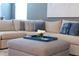 Comfortable living room showcasing an ottoman, a large couch, and throw pillows at 14355 59Th E Cir, Bradenton, FL 34211