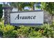 Elegant community entrance sign surrounded by vibrant flowers and lush greenery at 14355 59Th E Cir, Bradenton, FL 34211