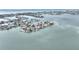 Expansive aerial shot of a waterfront community, showing homes with boat access and views of the city skyline at 16103 6Th E St, Redington Beach, FL 33708