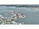 Stunning aerial view of waterfront homes with boat docks and access to the bay, surrounded by calm water at 16103 6Th E St, Redington Beach, FL 33708