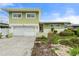 Charming two-story home with attached garage and well-maintained landscaping at 16103 6Th E St, Redington Beach, FL 33708