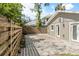 Backyard featuring a wood fence, gravel hardscape, and a brick paver patio at 1622 Wisconsin Ln, Sarasota, FL 34239