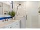 Stylish bathroom with a glass-enclosed shower, white vanity, and decorative mirror at 1622 Wisconsin Ln, Sarasota, FL 34239