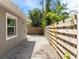 Side yard with gravel hardscape and wood fence offering privacy at 1622 Wisconsin Ln, Sarasota, FL 34239