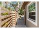Side yard with gravel hardscape, brick pavers, and wood fence creating privacy at 1622 Wisconsin Ln, Sarasota, FL 34239