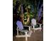 Relaxing backyard featuring comfortable Adirondack chairs, set within lush, tropical surroundings at 1633 Ridgewood Ln, Sarasota, FL 34231