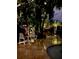 Charming backyard setting with white Adirondack chairs amidst the tropical landscaping by the pool at 1633 Ridgewood Ln, Sarasota, FL 34231