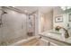 Elegant bathroom featuring a walk-in shower with tile surround, granite countertops, and modern fixtures at 1633 Ridgewood Ln, Sarasota, FL 34231