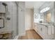 Modern bathroom with a glass shower, double vanity, and granite countertop at 1633 Ridgewood Ln, Sarasota, FL 34231