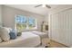 Comfortable bedroom with natural light, closet, stylish decor, coastal color palette, and hardwood flooring at 1633 Ridgewood Ln, Sarasota, FL 34231