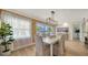 Bright dining room featuring wood paneling, white table set, and pool views at 1633 Ridgewood Ln, Sarasota, FL 34231