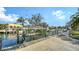 View of a private dock featuring a boat lift on a canal with nearby waterfront homes at 1633 Ridgewood Ln, Sarasota, FL 34231
