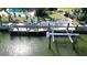Waterfront home featuring a private dock with a boat lift, seating area, and easy access to the open water at 1633 Ridgewood Ln, Sarasota, FL 34231