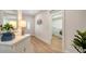 Bright entryway features a white cabinet, decorative mirror, and access to the laundry room for added convenience at 1633 Ridgewood Ln, Sarasota, FL 34231