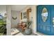 Inviting entryway featuring a blue door, wooden shutters, decorative lantern, and bench at 1633 Ridgewood Ln, Sarasota, FL 34231