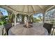 Cozy gazebo featuring a fire pit, surrounded by lush greenery and scenic waterfront views at 1633 Ridgewood Ln, Sarasota, FL 34231