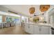 Open kitchen with stainless steel appliances, white cabinets, and a large island perfect for meal prep and casual dining at 1633 Ridgewood Ln, Sarasota, FL 34231