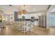 Open kitchen featuring white cabinets, stainless steel appliances, and a breakfast bar with seating at 1633 Ridgewood Ln, Sarasota, FL 34231