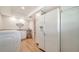 Bright laundry room with white appliances, wooden floors, sink, counter space, and charming starfish wall decor at 1633 Ridgewood Ln, Sarasota, FL 34231