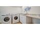 Functional laundry room with modern washer and dryer, granite countertops, and ample storage at 1633 Ridgewood Ln, Sarasota, FL 34231