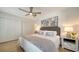 Comfortable main bedroom with neutral tones, ceiling fan, and double door closet at 1633 Ridgewood Ln, Sarasota, FL 34231