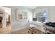 Well-lit home office featuring a white desk, modern chair, and views of the exterior at 1633 Ridgewood Ln, Sarasota, FL 34231