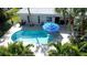 An aerial view showcasing a freeform pool with surrounding tropical landscaping at 1633 Ridgewood Ln, Sarasota, FL 34231