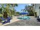 Inviting pool area with a lush tropical landscape, comfortable lounge chairs, and serene blue waters for relaxation and recreation at 1633 Ridgewood Ln, Sarasota, FL 34231