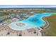 Community's large beach lagoon, waterslides, watersports, white sand beach and recreation facilities from an aerial perspective at 16810 Scuba Crest St, Wimauma, FL 33598