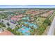 Community aerial view showcases tennis courts, swimming pool, clubhouse, landscaping, and residential homes at 16810 Scuba Crest St, Wimauma, FL 33598