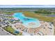 Stunning overhead of Epperson Lagoon with its sandy beach, umbrellas, and clear, blue water at 16810 Scuba Crest St, Wimauma, FL 33598