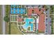 Aerial view of community clubhouse, pool, tennis courts, bocce ball, and meticulous landscaping at 16810 Scuba Crest St, Wimauma, FL 33598