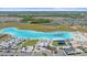 Gorgeous aerial view of Epperson Lagoon featuring its white sand beach and floating obstacle course at 16810 Scuba Crest St, Wimauma, FL 33598