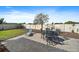 Relaxing backyard featuring a patio, a lounge chair, a dining set, and a well maintained lawn area at 16810 Scuba Crest St, Wimauma, FL 33598