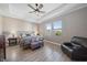Spacious bedroom featuring two bright windows, a ceiling fan, a decorative bed frame, and luxury vinyl floors at 16810 Scuba Crest St, Wimauma, FL 33598