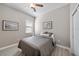 Comfortable bedroom with neutral paint, gray plank flooring, and a ceiling fan, creating a tranquil space at 16810 Scuba Crest St, Wimauma, FL 33598