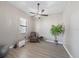 Bonus room with neutral paint, wood flooring, ceiling fan, and window for natural light at 16810 Scuba Crest St, Wimauma, FL 33598