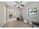 Bonus room with neutral paint, wood floors, ceiling fan, and window to provide natural light at 16810 Scuba Crest St, Wimauma, FL 33598