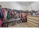 Walk-in closet featuring hardwood floors, clothing racks, shelving, and a chest of drawers at 16810 Scuba Crest St, Wimauma, FL 33598