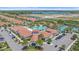 Aerial view of community center with a pool, tennis courts and parking at 16810 Scuba Crest St, Wimauma, FL 33598