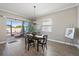 Dining area with wood floors, modern light fixture, and sliding glass doors to the outside patio at 16810 Scuba Crest St, Wimauma, FL 33598