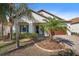 Charming home with a well-manicured front yard and a two-car garage and some lovely palm trees at 16810 Scuba Crest St, Wimauma, FL 33598