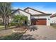 Charming home with a well-manicured front yard and a two-car garage on a brick driveway at 16810 Scuba Crest St, Wimauma, FL 33598